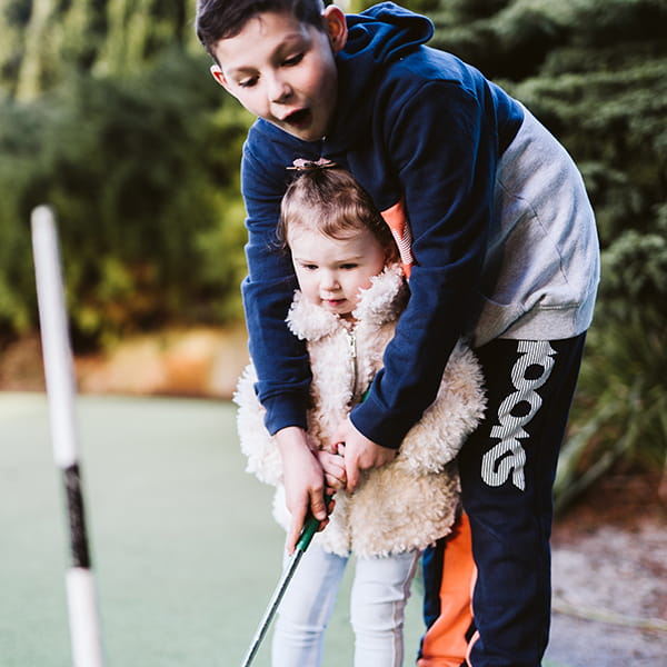 Kids playing mini-golf