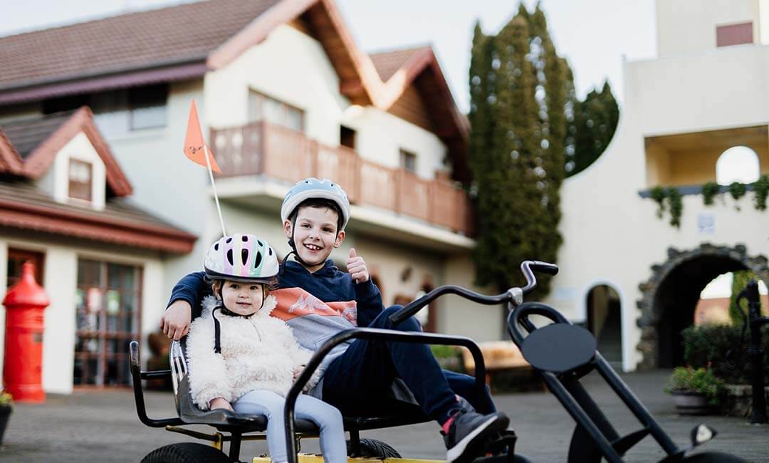 Kids riding pedal cart